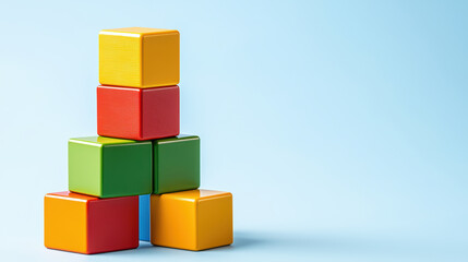 Obraz premium Colorful building blocks stacked creatively against light blue background