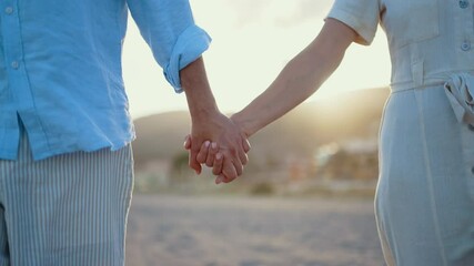 Beautiful happy senior couple dating at the seaside during summertime - Mature married couple in love bonding outdoors at the beach, concepts about elderly lifestyle, relationship and quality of life
