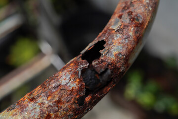 A heavily rusted steel pipe frame.