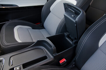 Modern car interior detail: center console with armrest and storage