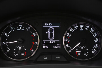 Car dashboard displaying speed RPM fuel level and time