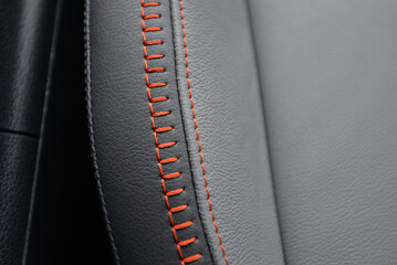 Close up of gray leather upholstery with orange stitching High quality texture and detail