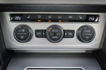 Car climate control panel with temperature display and buttons for various settings