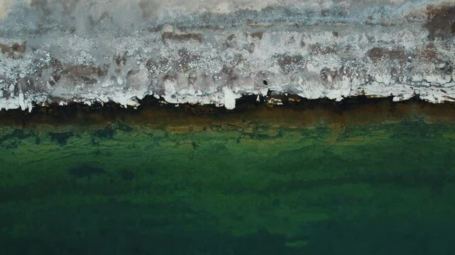 A bird's eye view of the shores of Lake Van, taken with a horizontal panning motion using a drone. The clarity of the lake, its soda structure and the different layers on the shore are remarkable.