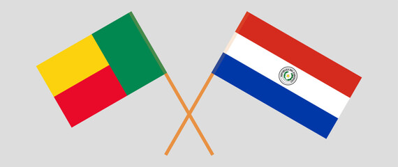 Crossed flags of Benin and Republic of Paraguay. Official colors. Correct proportion. Vector illustration