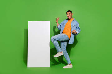 Full size photo of overjoyed energetic male raise fists in victory win new smartphone isolated on...