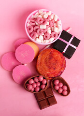 set of sweets and gift on pink background