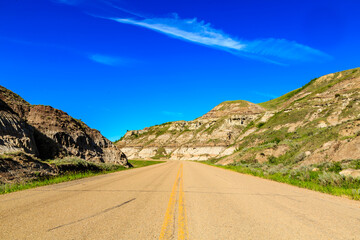 A road with a blue sky in the background