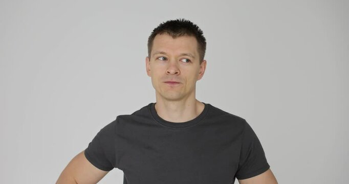 Casual man with handsome expression winks to the side