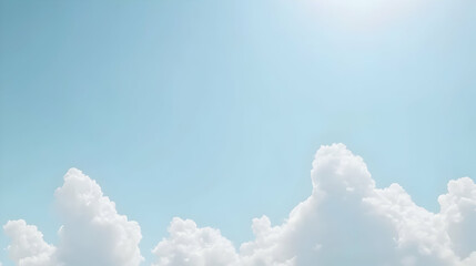 Serene landscape of fluffy white cumulus clouds against a clear, pale blue sky. Perfect for background images, websites, or design projects needing a peaceful and airy atmosphere.