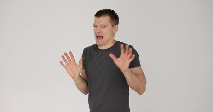 Man showing disgust and aversion on white background.
