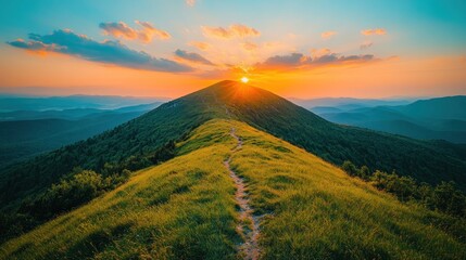 Fototapeta premium Majestic sunset over mountain peak with grassy trail.
