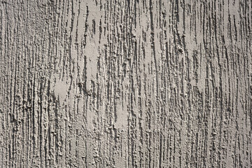 Grey cement wall with roughly surface and scratch line. Background and texture, close-up.