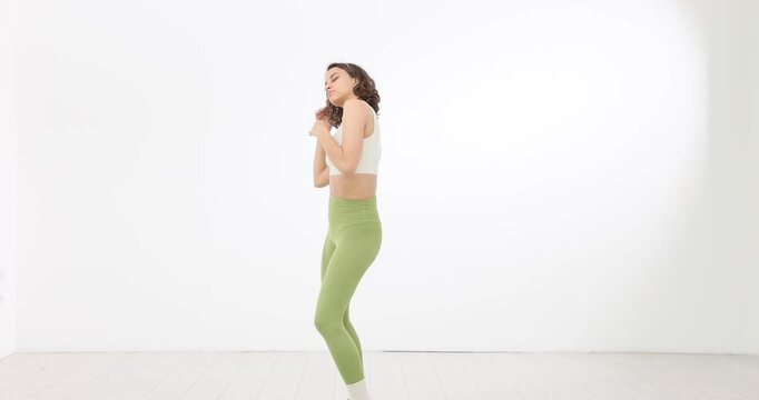 Woman doing dance workout on white background
