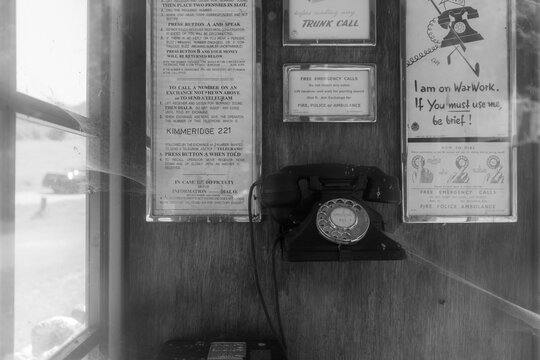 Old analogue telephone in an obsolete landline network with cobwebs. Digital upgrade.