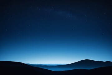 night sky with stars and mountains in the distance