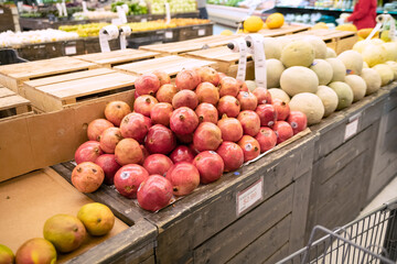 ripe pomegranates in great variety on the farm store counter.