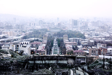 Misty view of Yerevan city from a high vantage point, showcasing a blend of Soviet-era and modern...