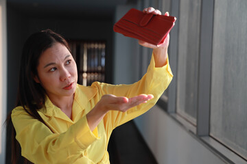 Middle aged woman getting having no money, concept of indebted Asian aunt with debt but no money,...