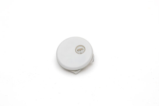 Used Glucose Monitoring Sensor After Removal Isolated on White Background