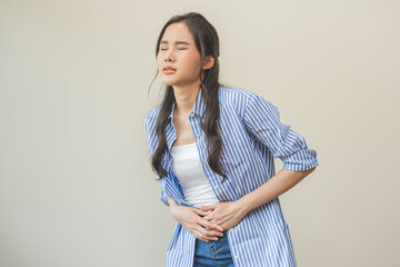 Flatulence asian young woman intolerance hand in stomach ache, suffer from food poisoning,...