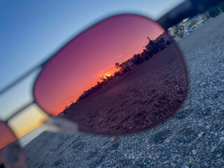 Sunset Reflection on Beach in Spain seen through sunglasses