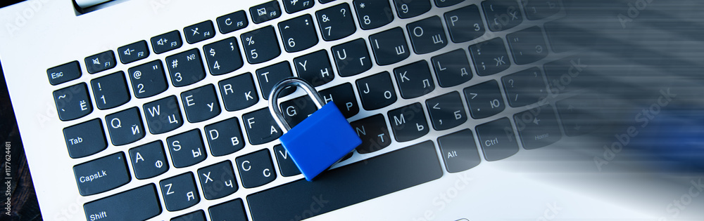 Poster laptop computer on desk with padlock on table.