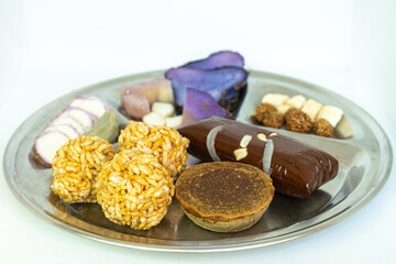 A Plate of jaggery, sesame balls, yam, sweet potato for Maghe Sankranti Festival or Pre Workout Meal