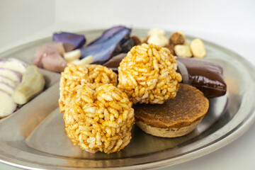 A Plate of jaggery, sesame balls, yam, sweet potato for Maghe Sankranti Festival or Pre Workout Meal