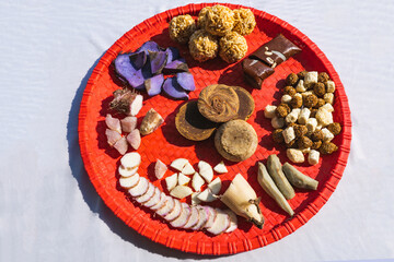 A Plate of jaggery, sesame balls, yam, sweet potato for Maghe Sankranti Festival or Pre Workout Meal