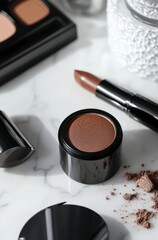 Luxury brown cosmetics on marble surface with lipstick and eyeshadow