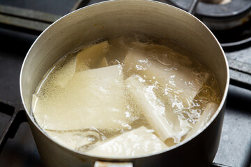 The dough for khinkali is thin and boiled in meat broth in a saucepan with spices. Horizontal photo.