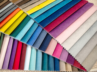  Samples of multicolored fabrics. Catalog of fabrics for upholstered furniture.Choosing the color of the sofa. Background for the textile industry.