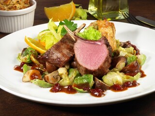 Medium Deer Steak with Vegetables on Cranberry Sauce