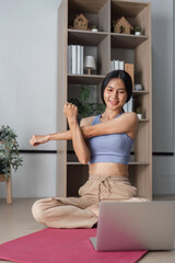 Young Woman Practicing Yoga at Home in a Modern Living Room Setting with Natural Light and Minimalist Decor