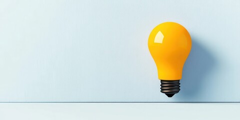 Bright Yellow Light Bulb on Light Blue Background