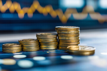 Stacks of coins on financial chart symbolize economic growth and investment