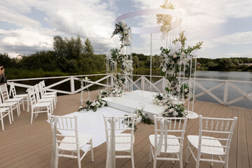 stylish beautiful wedding decoration for a celebration near the lake