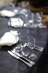clear glass goblets with utensils on a festive table
