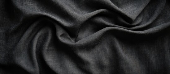 Fototapeta premium Elegant Black Cloth Fabric Texture Background with Smooth Waves and Ample Copyspace for Text or Design Elements