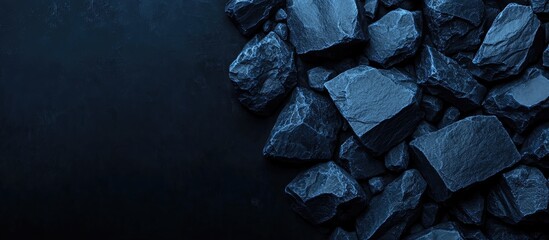 Blue stone fragments arrangement with dark background and ample copy space for text and branding purposes in a modern design layout