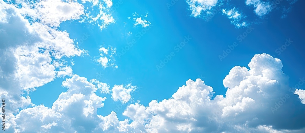Poster blue sky with fluffy white clouds offering ample empty space for text or advertisements in a serene 