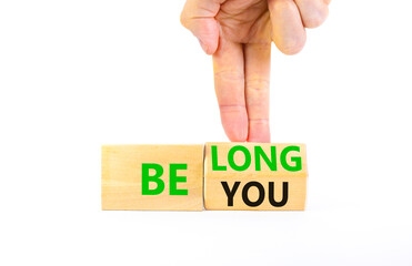 Belonging and belong symbol. Concept words Be you Belong on beautiful wooden block. Beautiful white background Businessman hand. Business motivational belonging and belong concept. Copy space.