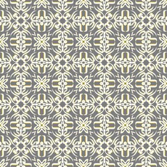 Seamless pattern featuring intricate yellow and white ornamental shapes on a gray background, forming a symmetrical and sophisticated design.
