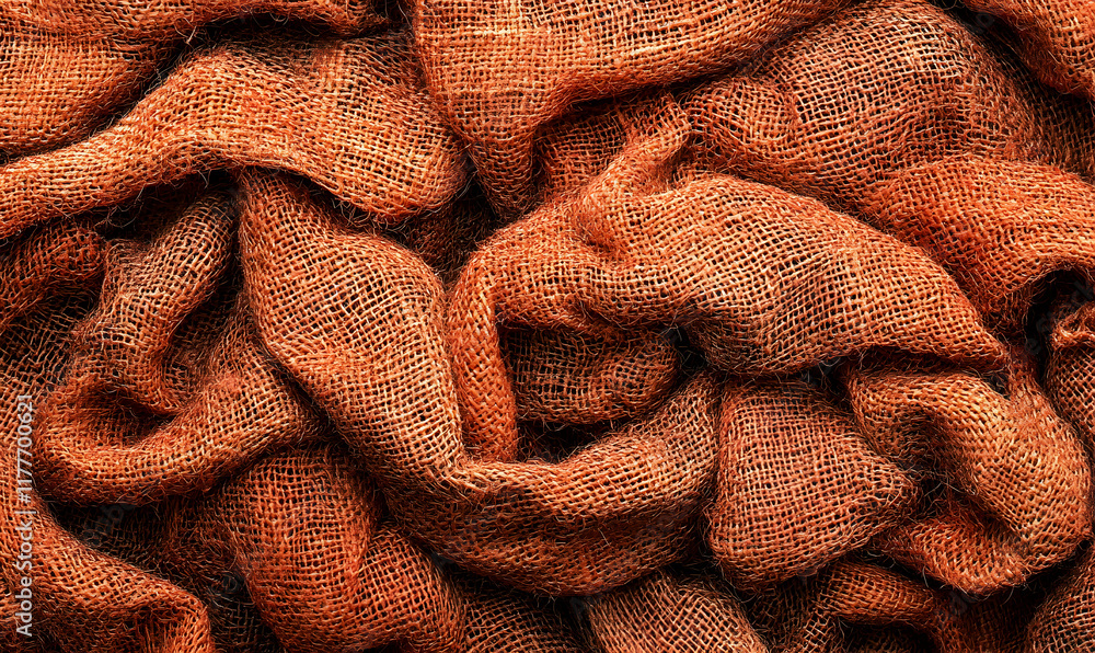 Poster close-up texture of rustic orange burlap fabric, showing intricate weave and folds. ideal for backgr