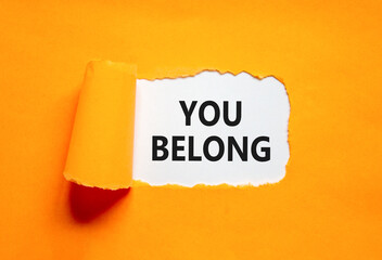 Belonging and you belong symbol. Concept words You belong on beautiful white paper. Beautiful orange paper background. Business belonging and you belong concept. Copy space.
