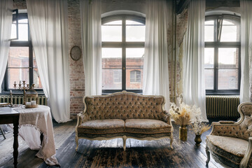 Comfortable vintage-style couch in a classic living room with large windows
