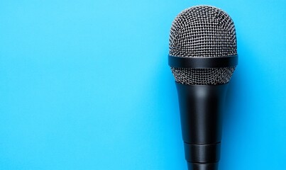 Black microphone on blue background; podcast, interview, speech