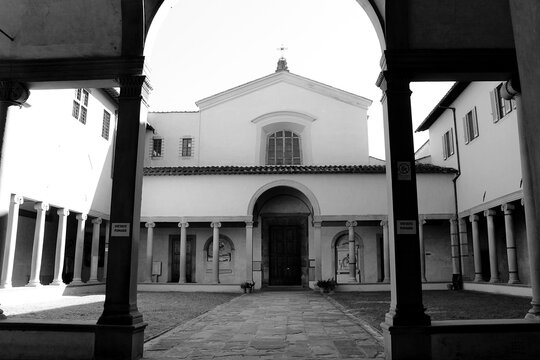 Historic Santa Maria Maddalena dei Pazzi Church in Florence, Italy framed through an elegant archway with soft lighting
