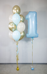 blue foil number 1 balloon and bunch of latex helium balloons for birthday
